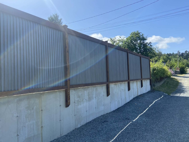 A fencing installation done by West Coast Fencing, displayed as a work sample.